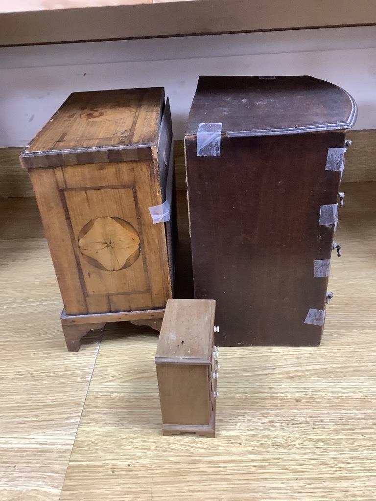 An 18th century Dutch inlaid walnut miniature chest of drawers, a 19th century mahogany bow-fronted miniature chest and another miniature chest, tallest 31cm